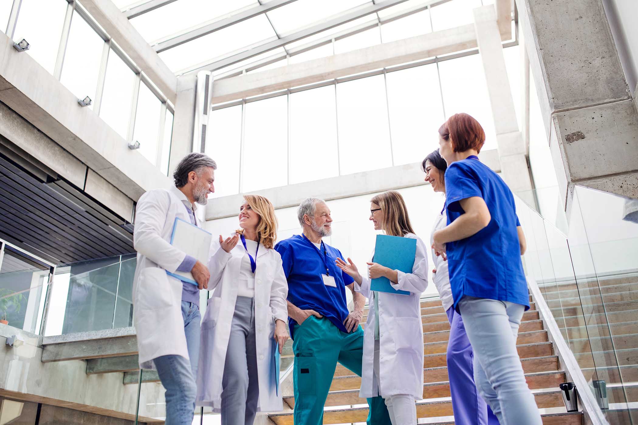 group-of-doctors-standing-on-staircase-talking-TJUQK74.jpg