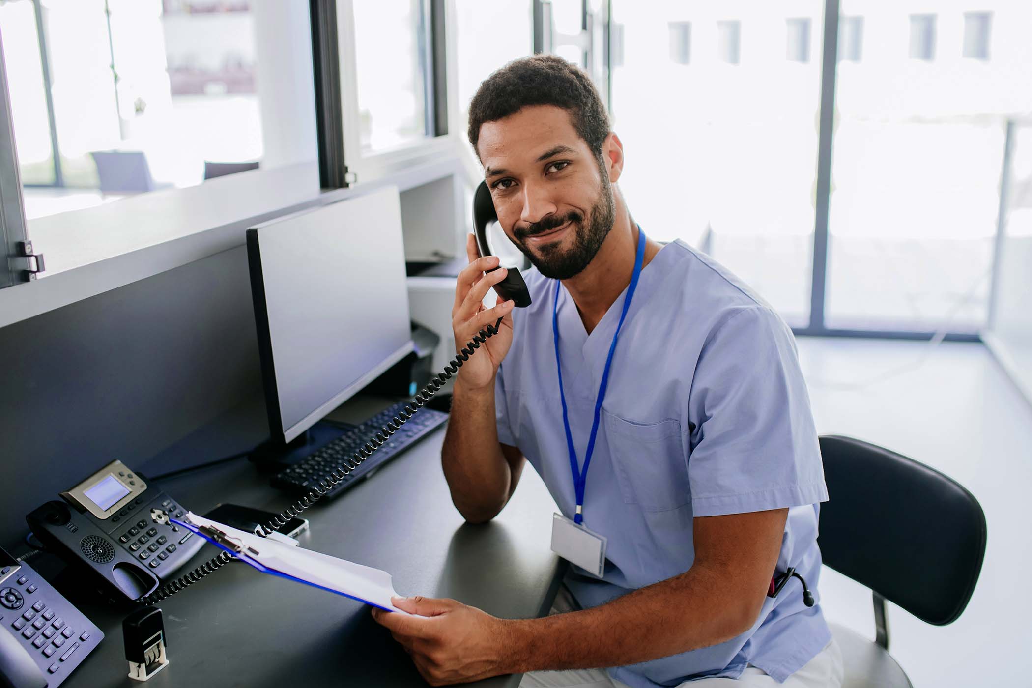 portrait-of-young-multiracial-doctor-sitting-at-re-XGVTY4V.jpg